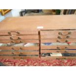 A twelve drawer watchmakers chest housing various spare parts and tools