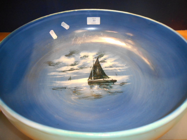 An unusual large Royal Doulton blue and green glazed bowl the interior hand-painted with a sailing