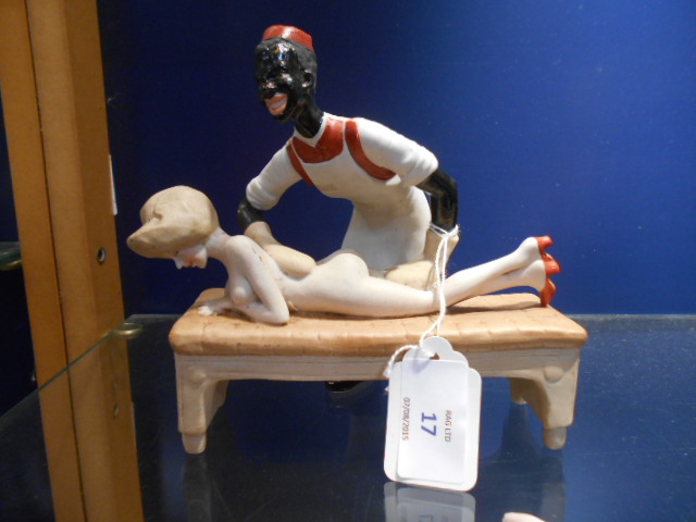 A Continental porcelain figurine depicting a naked female having a massage from a male masseuse