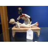 A Continental porcelain figurine depicting a naked female having a massage from a male masseuse