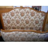 A French 4ft 6" walnut framed double bed upholstered in floral tapestry style fabric with floral