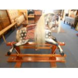 A mid-20th C Stephenson & Sons dapple grey rocking horse with leather studded saddle and reins and