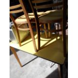 A 1950's / 60's beech and yellow Formica kitchen table and two matching chairs