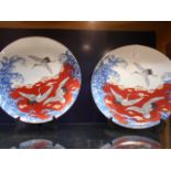 A pair of porcelain chargers with crane decoration