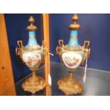 A pair of 19th C Sevres turquoise porcelain and gilt metal vases having pictorial cartouches of