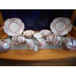 A Staffordshire tea set having pink and gilt border with floral decoration