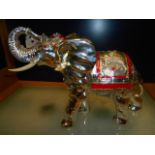 A late 20th C silver-plated Indian elephant with raised trunk hand-painted with jewels and gilt