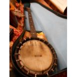 A early 20th C 'Standard BB Quality' banjo the back stained with scrolls and shells,
