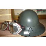 Tin helmet and pair of flying goggles