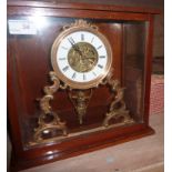 Brass clock with hanging cherub in mahog