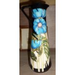 Moorcroft tall vase decorated with blue flowers on black ground ht approx. 24cm with impressed