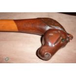 Wooden walking stick with carved horse's head handle