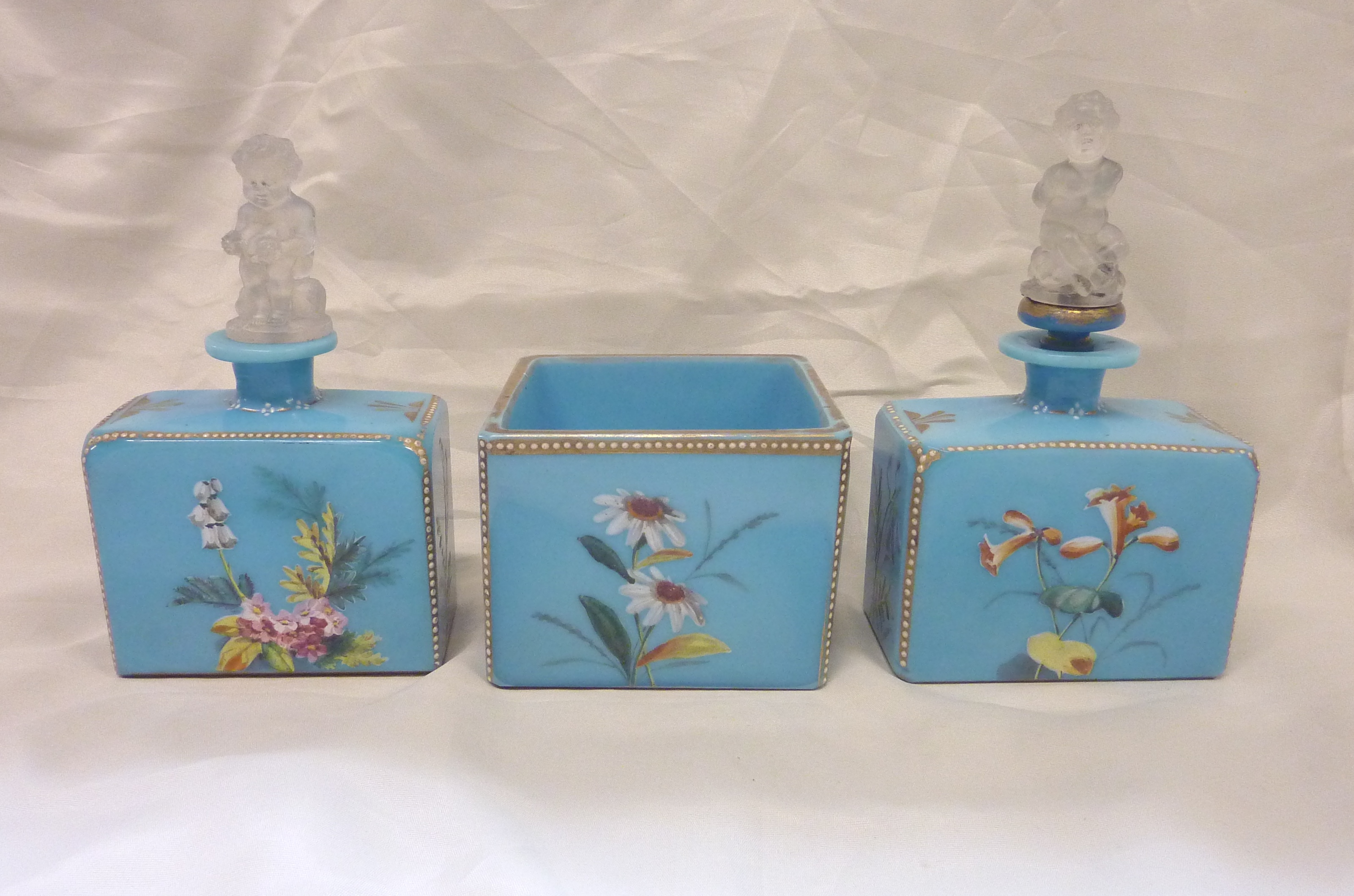 Early 20thC continental blue glass dressing table set with painted floral and gilt detail