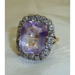 Boxed amethyst and diamond dress ring with large faceted stone in gold mounts