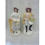 Pair of Staffordshire figures of fisherman and fisherwoman both carrying baskets of fish (2) (35cm