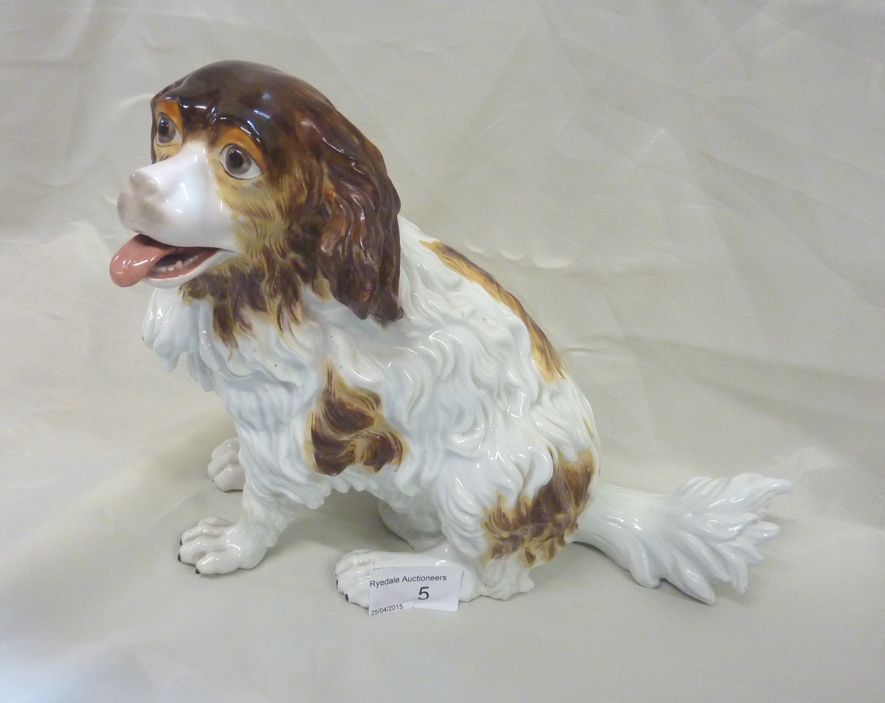 Continental figure of a seated spaniel with impressed mark F & M to the base