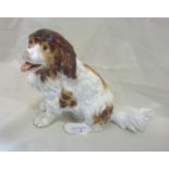 Continental figure of a seated spaniel with impressed mark F & M to the base