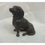 Earthenware figure of a seated Dachshund with inset glass eyes height (16cm)