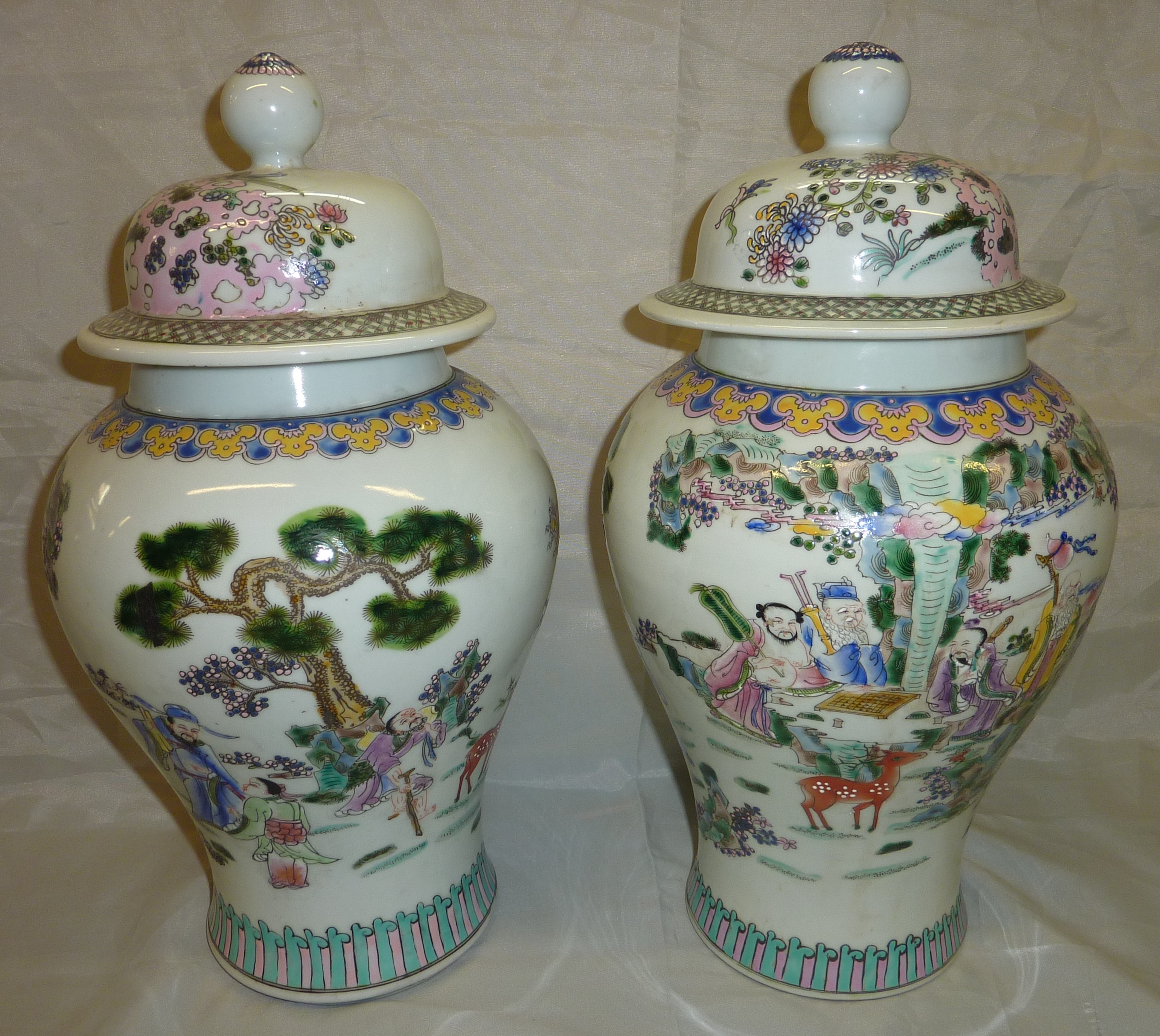 Pair of Oriental vases depicting various scenes including warriors on horseback with six digit