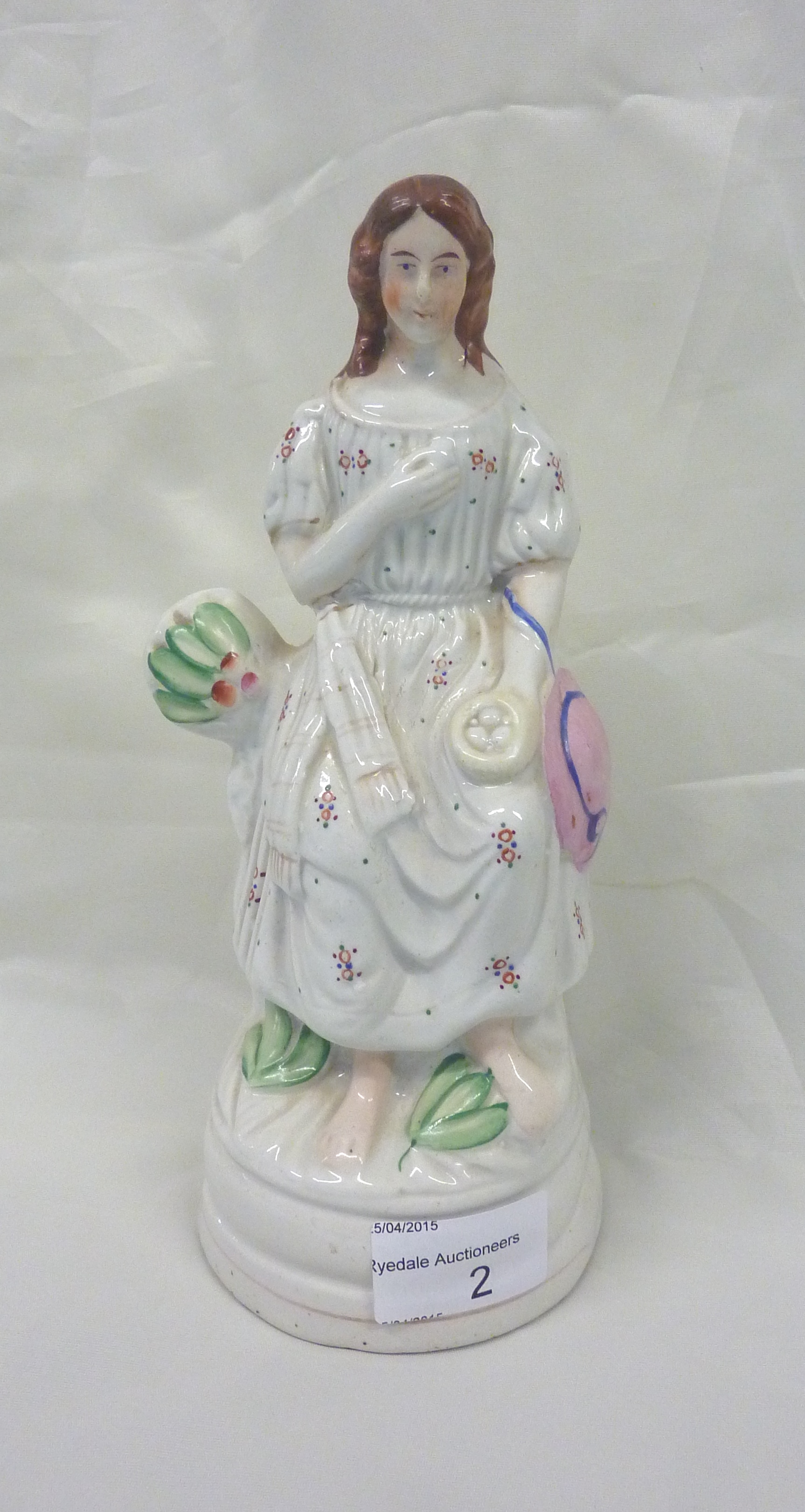 Early Staffordshire figure of a seated girl with egg basket (height 23cm)