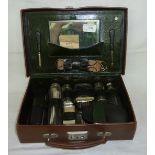 Small brown leather travelling case with