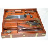 Mahogany and brass bound travelling surgeons case with fitted interior with various implements,