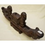 Carved wood tribal group of a canoe with ships mast in the form of a head with central box