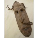 Mid to late 19thC New Guinea carved wood mask with leather tassels,