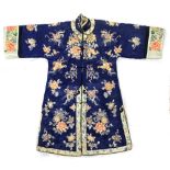 An early C20th Chinese embroidered blue silk robe, with fur lining (see illustration).