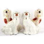Property of a lady - two pairs of Victorian Staffordshire models of seated spaniels, the taller pair