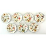 Property of a gentleman - a set of seven small faience plates, painted with flowers, blue painted