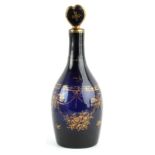 A C19th gilt decorated blue glass decanter with heart shaped stopper, 12.2ins. (31cms.) high (