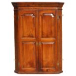 Property of a gentleman - a George III fruitwood corner wall cabinet with twin fielded panelled