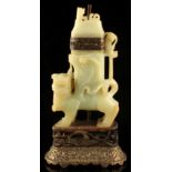 Property of a gentleman - a carved pale celadon jade model of a standing temple lion, adapted as a