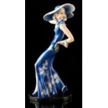 Property of a gentleman - an Art Deco Goldscheider figure of a young lady wearing a blue dress,