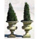 Property of a deceased estate - a pair of reconstituted stone garden urns, with mask decorations,