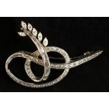 Property of a lady - a platinum or white gold diamond ribbon brooch, probably French, set with