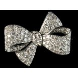 An unmarked white gold & diamond ribbon brooch, pave set with brilliant cut diamonds, the