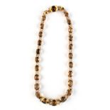 A citrine necklace, the twenty-six oval cut graduated citrines in an unmarked yellow gold setting,