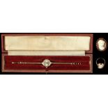 Property of a deceased estate - a boxed lady's Garrard 9ct gold cased wristwatch on 9ct gold