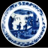 A Chinese blue & white plate, Kangxi period (1662-1722), painted with two ladies on terrace,