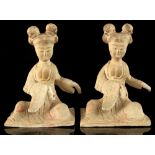 A pair of Chinese pottery figures of seated ladies, possibly Tang Dynasty, restorations to one,