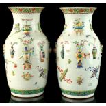 A pair of 19th century Chinese famille rose moulded baluster vases, each decorated in relief with