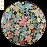 Property of a gentleman - a Chinese black ground famille rose millefleurs plate, re-glued rim