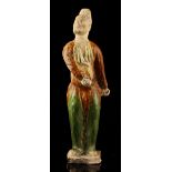 Property of a gentleman - a Chinese sancai glazed standing male figure, probably Tang Dynasty (618 -