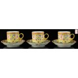 A set of three Chinese famille rose yellow ground 'Birthday' pattern cups & saucers, all with iron