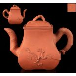 A 19th century Chinese Yixing teapot, of rectangular baluster form, decorated in relief with