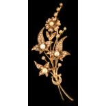 A 14ct yellow gold floral spray brooch set with seed pearls, 2.35ins. (6cms.) long, approximately