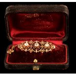 A late 19th / early 20th century unmarked gold three stone diamond brooch, the estimated total