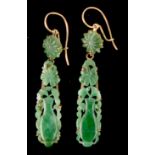 A pair of Chinese carved jadeite drop earrings, with unmarked yellow metal mounts, the jadeite